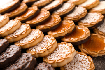 Many different sweet cookies on table