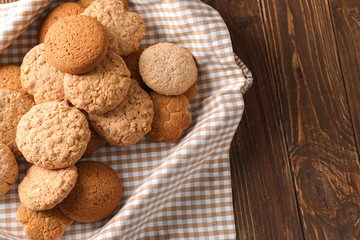 Box with sweet tasty cookies on wooden table