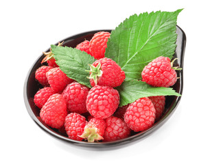 Bowl with ripe aromatic raspberries on white background