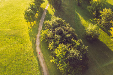 Drone aerial view of woman running in Nemunas Island park, Kaunas, Lithuania