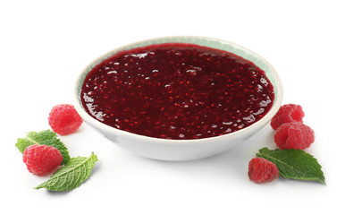 Bowl with raspberry jam on white background