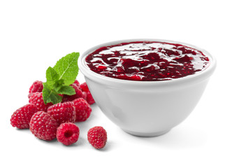 Bowl with raspberry jam on white background