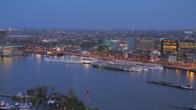pan over amsterdam city skyline illuminated at night