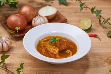 Chicken curry in a bowl / Vietnam chicken curry on wooden background