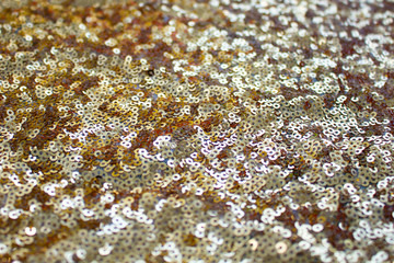 Sparkle golden cloth texture. Glitter shine background