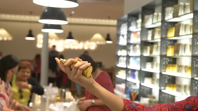 Saleswoman sprays perfume in the air to test - Slow Motion