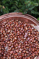 Copper pan of roasting chestnuts