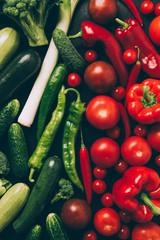 top view of red and green different vegetables on grey dark table