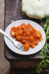 bush pumpkin in tomato sauce (a portion food) - conservation of products. food background