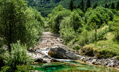 Naklejka na ściany i meble Idyllic mountain river in Lepena valley, Soca - Bovec Slovenia.
