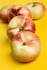 Melocotones Paraguayos sobre fondo amarillo aislado y liso. Vista superior