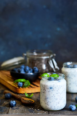 Fototapeta na wymiar Homemade yogurt with sesena chia and blueberries that have a dark background. Proper nutrition.