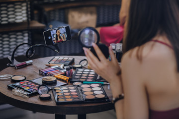 Night makeup. Dark-haired beautiful beauty blogger making video about her favorite night makeup