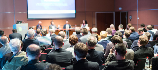 Speaker giving a talk in conference hall at business event. Audience at the conference hall....
