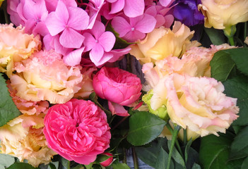 Floral background - beautiful fresh flowers, close-up. The work of a florist in a flower shop. Pink air hydrangea, carnation, purple eustoma.