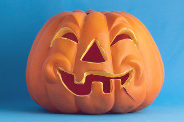 plastic halloween pumpkin on colorful background