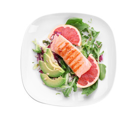 Plate with tasty grilled fish and vegetables on white background