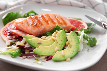 Tasty grilled fish and vegetables on plate, closeup