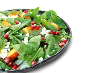 Plate with delicious healthy fresh salad on white background