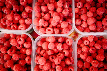 Berry fruits in baskets at a marketplace. mixed berries at eco market