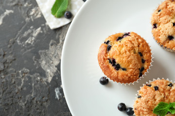 Tasty blueberry muffins on plate, closeup