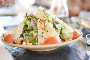 Closeup of fresh salad set on restaurant table