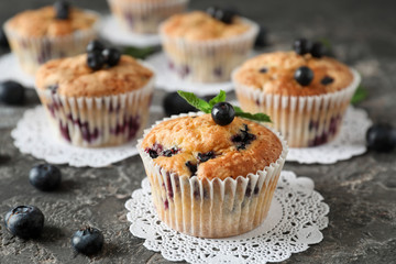 Tasty blueberry muffins on table