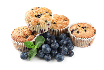 Tasty muffins with blueberries on white background
