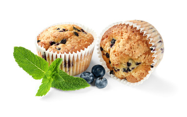Tasty muffins with blueberries on white background