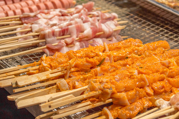 Meat prepared for roasting on a grill