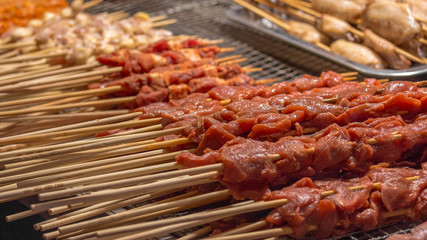 Meat prepared for roasting on a grill