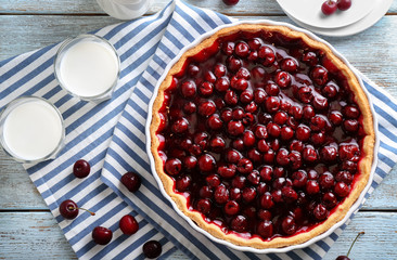 Tasty cherry pie on wooden table