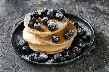 Delicious pancakes and berries on grunge table