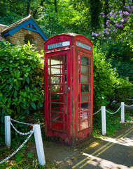 Old english red telephone box, booth in village, Dartmouth, Devon, United Kingdom, May 23, 2018