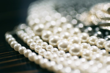 Pearl necklace close-up in the defocus on a dark background
