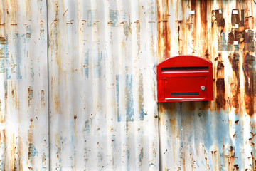 Red mailbox with zince tiles wall, red letter box with zince tiles wall