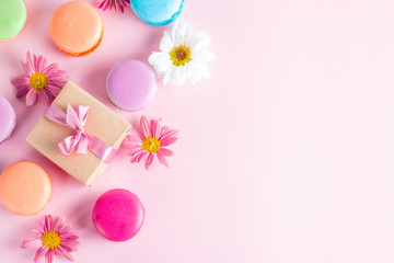 Photo of cake macarons, gift box, tea, coffee, cappuccino and flowers. Sweet romantic food macaroon concept. Morning breakfast and presents. Valentine's day concept.