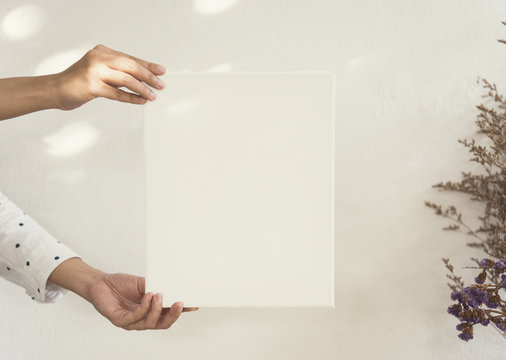 Hand Holding Blank White Photo Frame With Sunlight For Design Mockup Template.