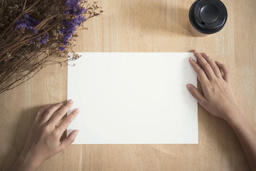 blank paper A4 flyer for mockup template design logo branding on wooden background.