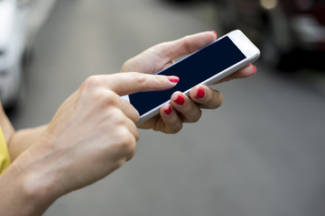 Woman texting on her mobile phone outdoor