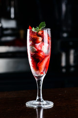 Dessert. Strawberries with ice-cream in the glass on the table, 