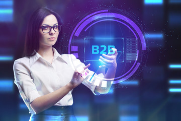 The concept of business, technology, the Internet and the network. A young entrepreneur working on a virtual screen of the future and sees the inscription: B2B