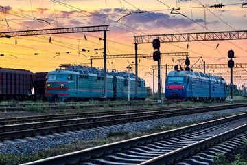 Fototapeta na wymiar trains and wagons, railroad infrastructure, beautiful sunset and colorful sky, transportation and industrial concept
