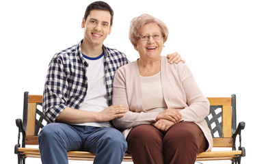 Obraz premium Young man and an elderly woman sitting on a bench