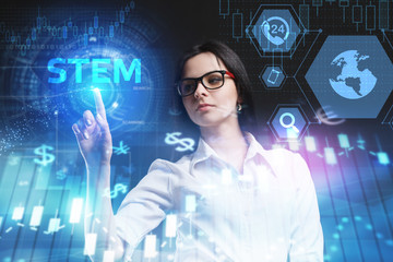 The concept of business, technology, the Internet and the network. A young entrepreneur working on a virtual screen of the future and sees the inscription: STEM