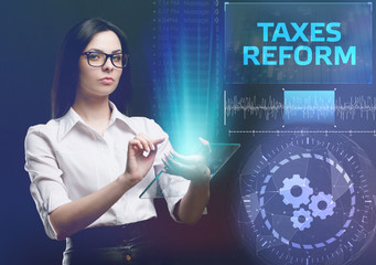 The concept of business, technology, the Internet and the network. A young entrepreneur working on a virtual screen of the future and sees the inscription: taxes reform