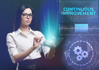 The concept of business, technology, the Internet and the network. A young entrepreneur working on a virtual screen of the future and sees the inscription: Continuous improvement