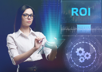 The concept of business, technology, the Internet and the network. A young entrepreneur working on a virtual screen of the future and sees the inscription: ROI