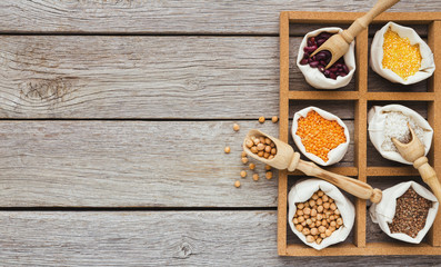 Cereals and legumes assortment on wooden table