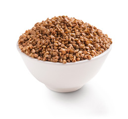 Dry buckwheat in ceramic bowl isolated on white